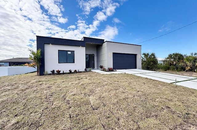 modern home with a garage and a front lawn