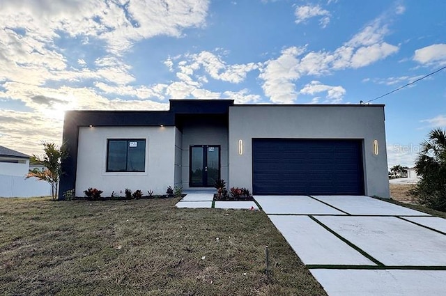 modern home with a garage and a front lawn