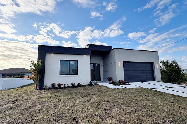 contemporary house with a front lawn and a garage