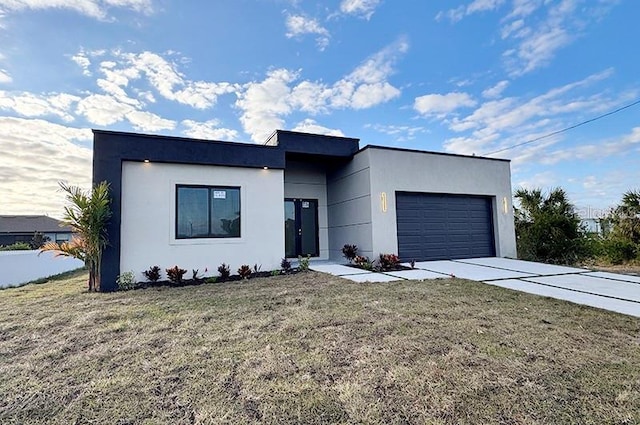 modern home with a front lawn and a garage