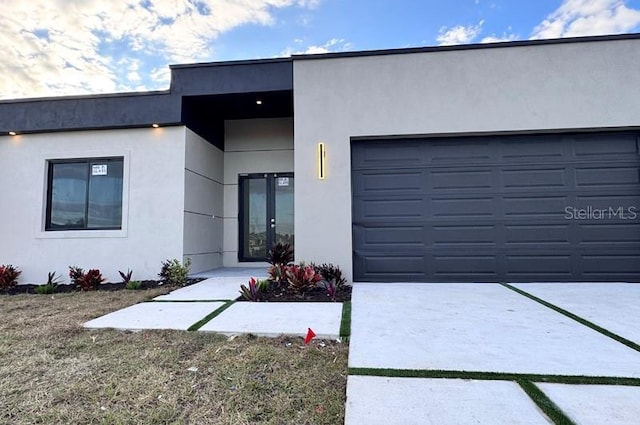 view of front of property with a garage and french doors