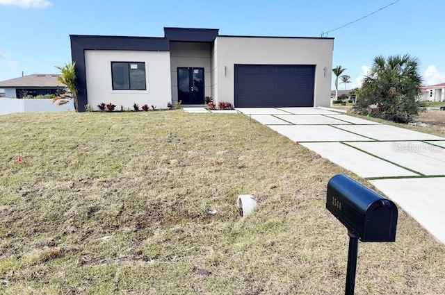 view of front of house featuring a garage and a front lawn