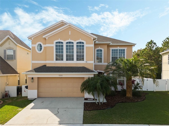 view of front of home with a front yard and a garage