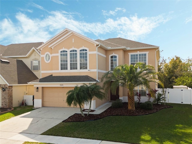 view of front of property with a front yard and a garage