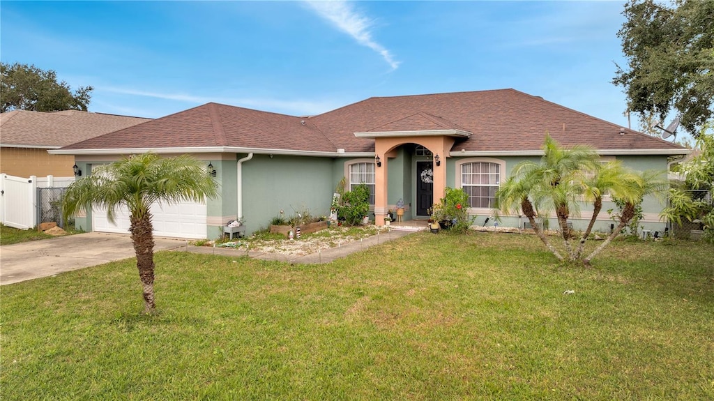 ranch-style home with a garage and a front lawn