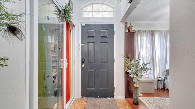 entrance foyer with light wood-type flooring and a textured ceiling