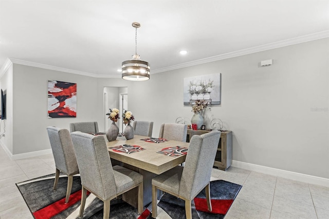 tiled dining area featuring ornamental molding and a chandelier