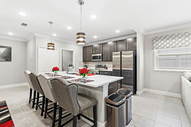 kitchen with visible vents, appliances with stainless steel finishes, a sink, and ornamental molding