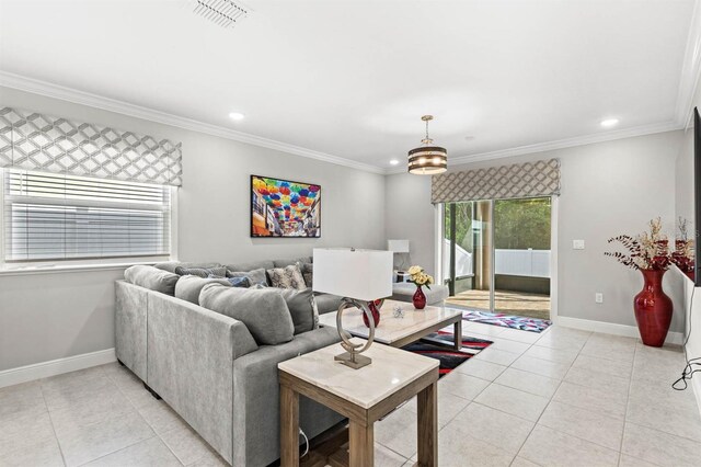 living room featuring light tile patterned flooring, a notable chandelier, and ornamental molding