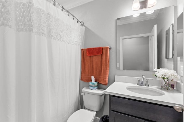 bathroom featuring a textured wall, ornamental molding, vanity, and toilet