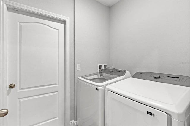 laundry room featuring washing machine and dryer and laundry area