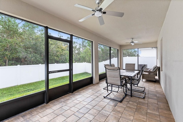 sunroom / solarium with a ceiling fan