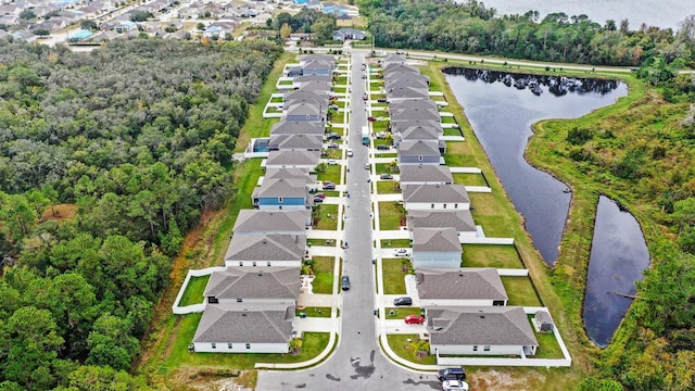 birds eye view of property featuring a water view and a residential view