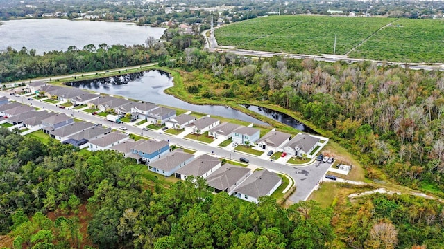 birds eye view of property with a water view and a residential view