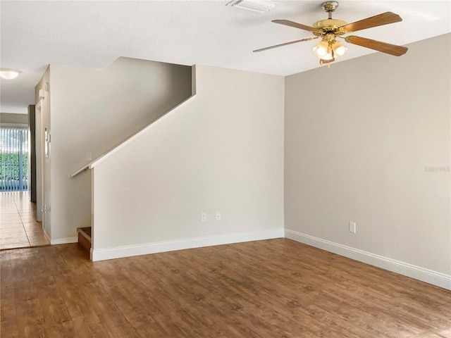 spare room featuring ceiling fan, a textured ceiling, and hardwood / wood-style flooring