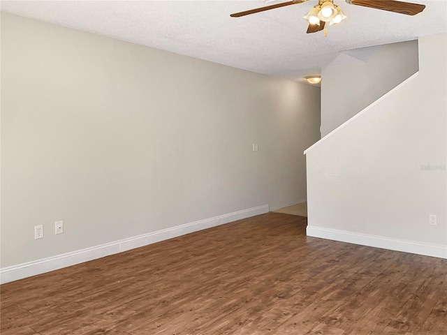 empty room featuring dark hardwood / wood-style flooring and a textured ceiling