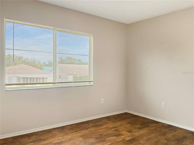 spare room with dark hardwood / wood-style floors