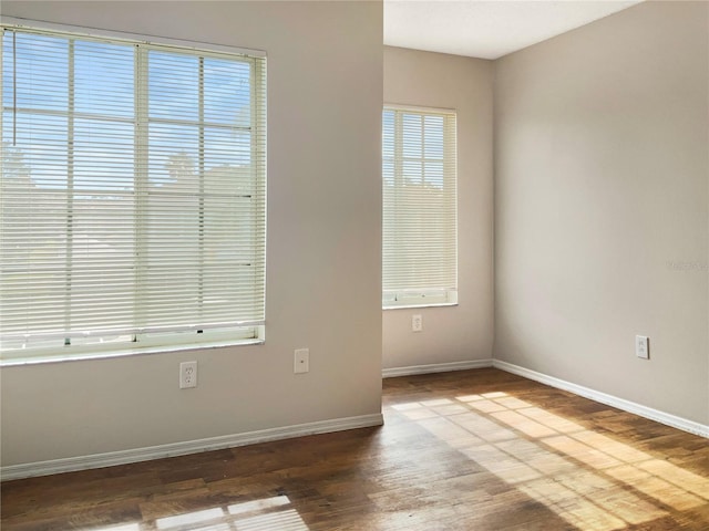 unfurnished room with hardwood / wood-style floors