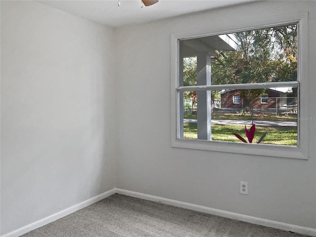 unfurnished room with ceiling fan, carpet floors, and a wealth of natural light