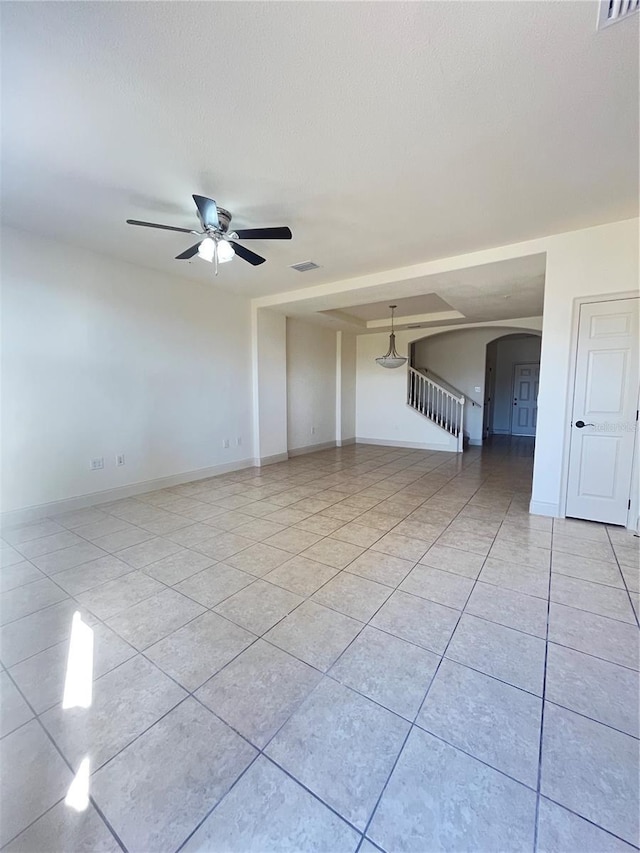 spare room featuring light tile patterned floors and ceiling fan