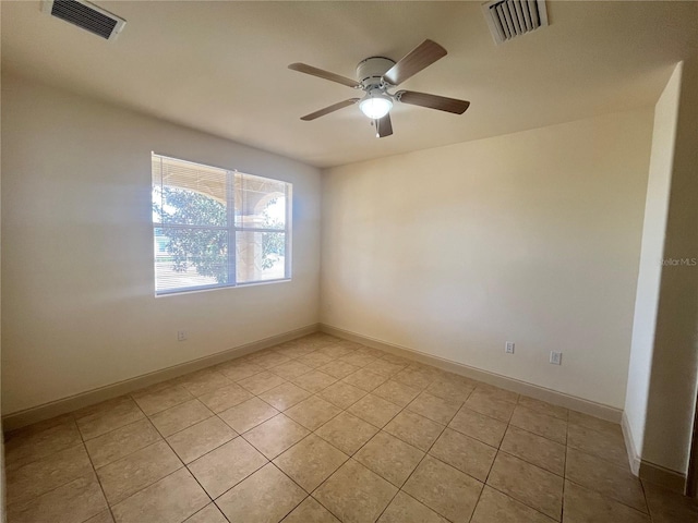 tiled empty room featuring ceiling fan