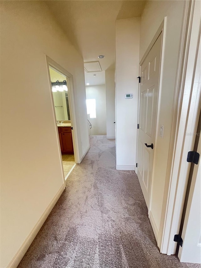 hall featuring light colored carpet