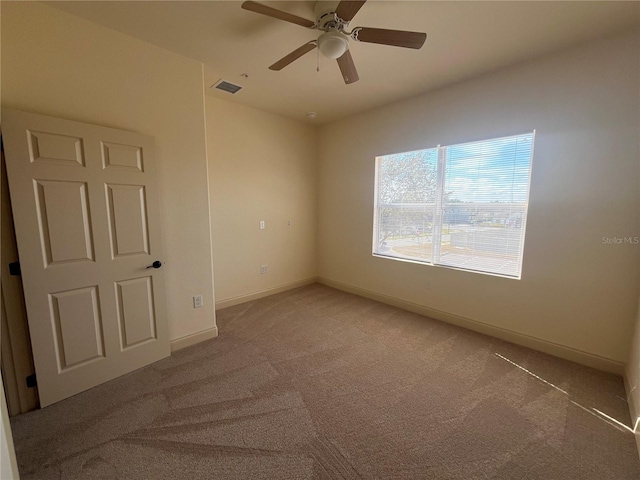 carpeted empty room featuring ceiling fan