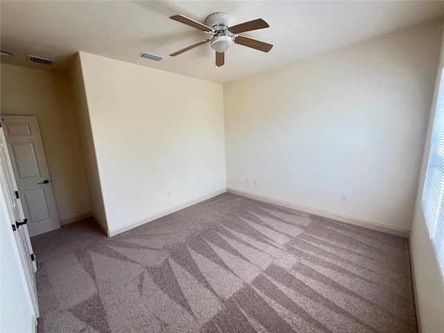 spare room featuring carpet floors and ceiling fan