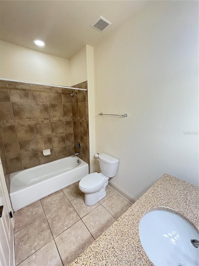 full bathroom with tile patterned flooring, sink, tiled shower / bath, and toilet