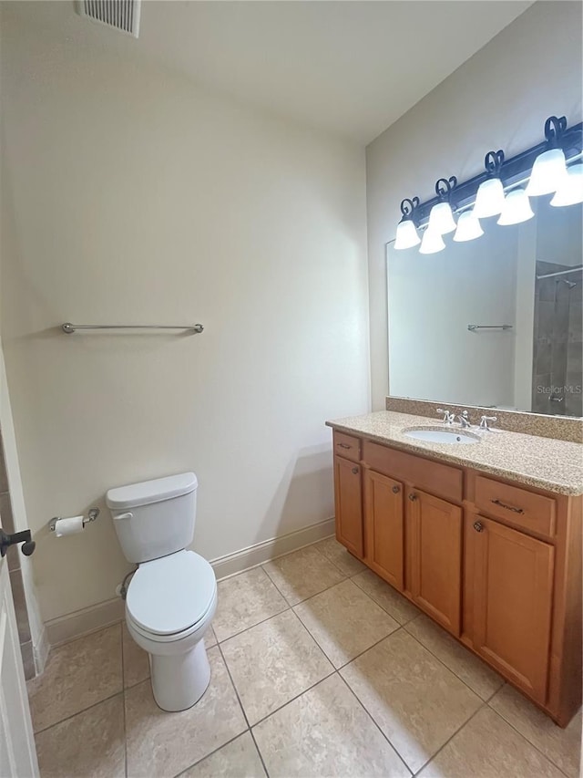 bathroom featuring tile patterned flooring, vanity, and toilet