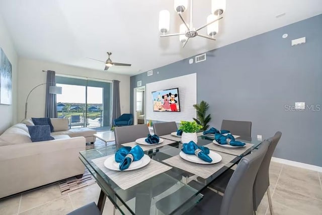 dining space with ceiling fan with notable chandelier