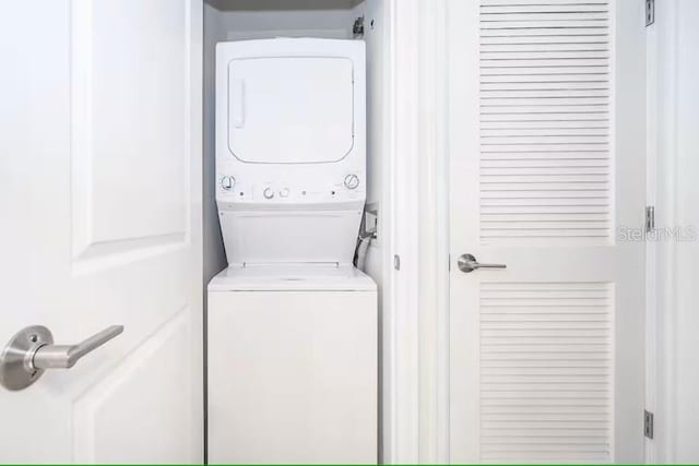 laundry area featuring stacked washer and dryer