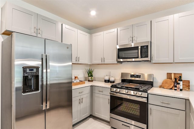 kitchen with gray cabinetry and appliances with stainless steel finishes