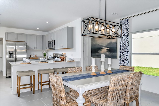 dining space with a notable chandelier and light tile patterned floors