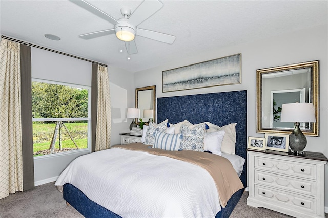 bedroom featuring ceiling fan and light carpet