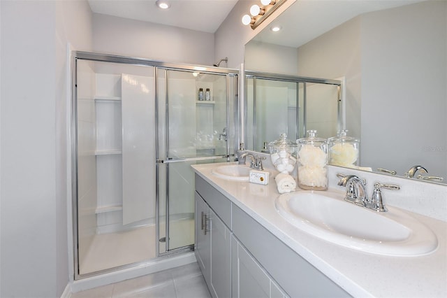 bathroom featuring tile patterned flooring, vanity, and an enclosed shower