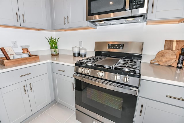 kitchen with stainless steel appliances and light tile patterned flooring