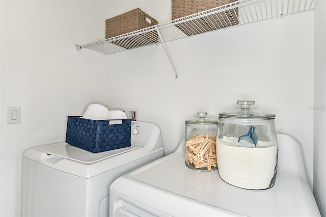 laundry area with washing machine and clothes dryer