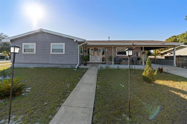 view of front facade with a carport and a front lawn