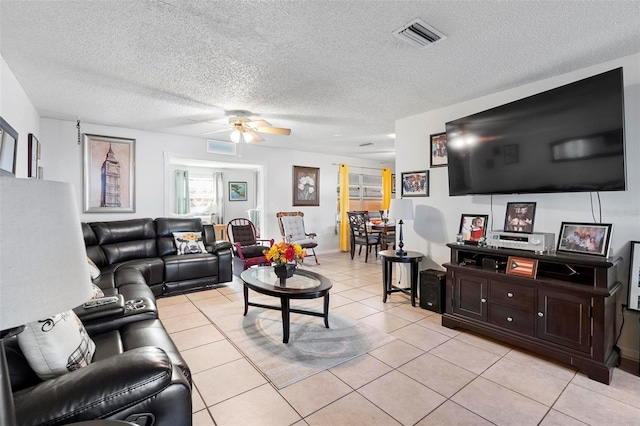 tiled living room featuring ceiling fan and a textured ceiling