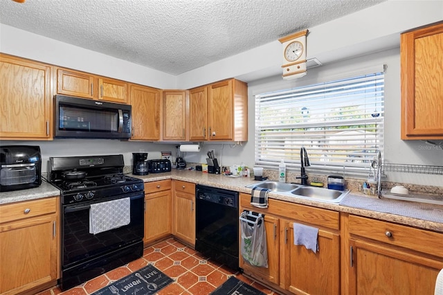 kitchen featuring a textured ceiling, sink, and black appliances