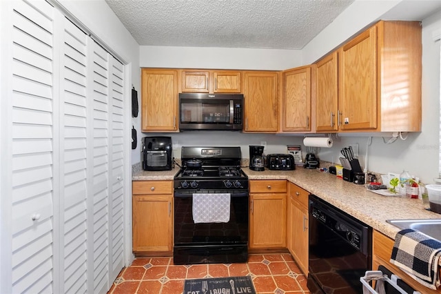 kitchen featuring a textured ceiling and black appliances