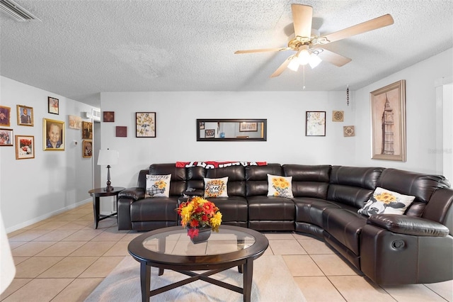 tiled living room featuring ceiling fan and a textured ceiling