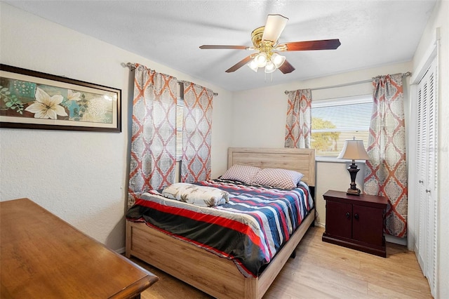 bedroom featuring a closet, ceiling fan, and light hardwood / wood-style flooring