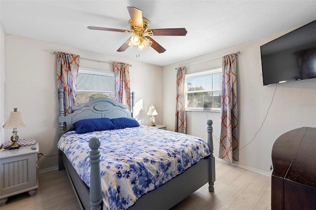 bedroom with ceiling fan and light hardwood / wood-style flooring