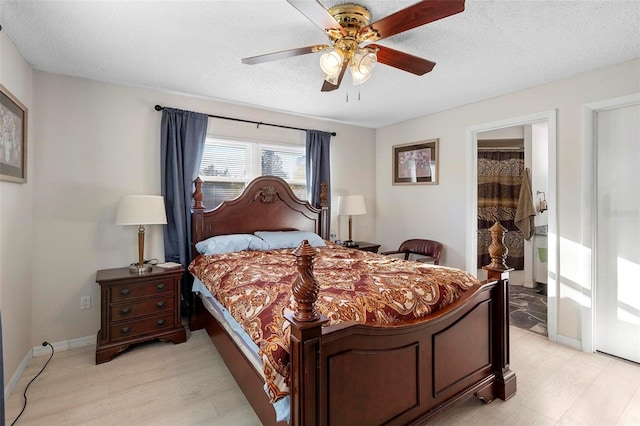 bedroom featuring ceiling fan, light hardwood / wood-style flooring, and a textured ceiling