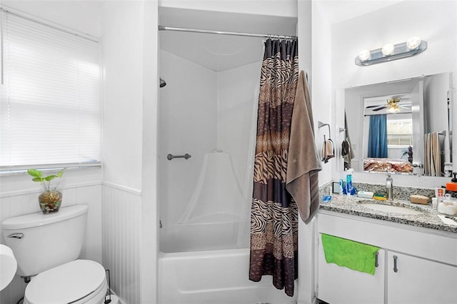 full bathroom with ceiling fan, vanity, shower / bath combo, and toilet