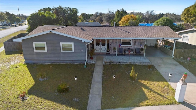 ranch-style house with a carport and a front lawn