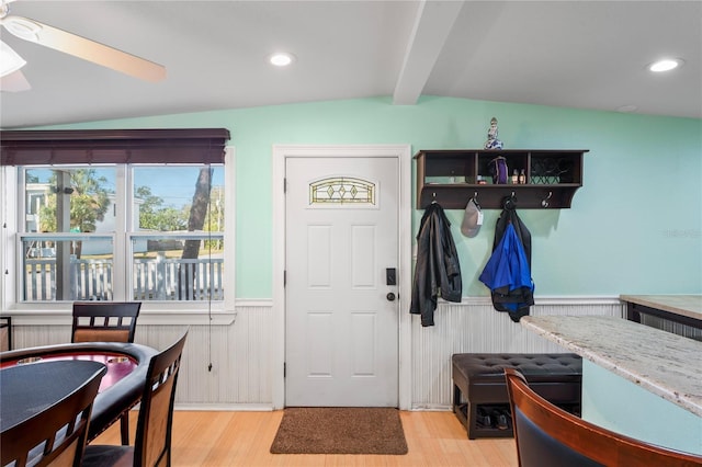 entrance foyer featuring ceiling fan, lofted ceiling with beams, and light wood-type flooring