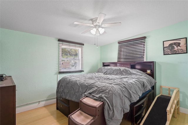 bedroom with ceiling fan and light hardwood / wood-style flooring